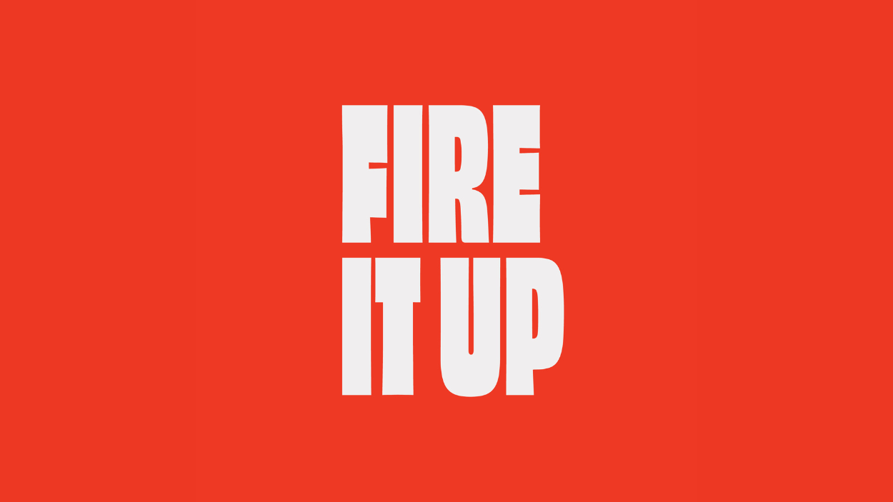 An orange background with Fire It Up written in white text.
