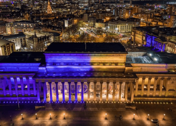St George's Hall with blue and yellow lights on the building.